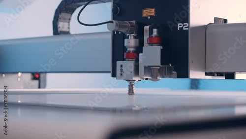 Close-up, cutting machine cuts paper in a printing house.