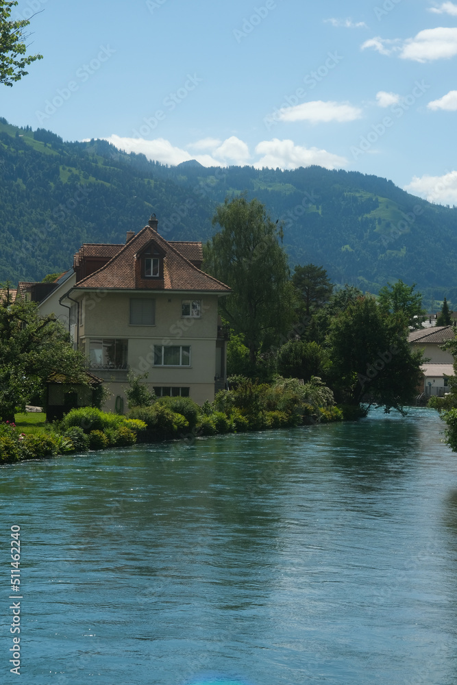 A picture with noise effect of building in front of Aare river at Interlaken.