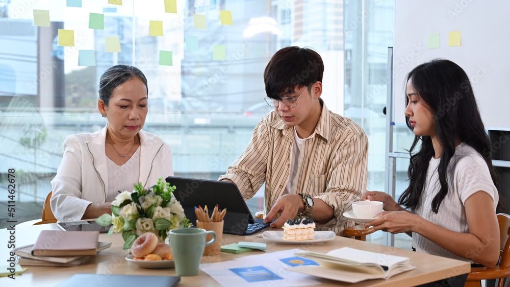 Team of professionals discussing project developing financial research, working together in modern office Team of professionals discussing project developing financial research, working together in modern office