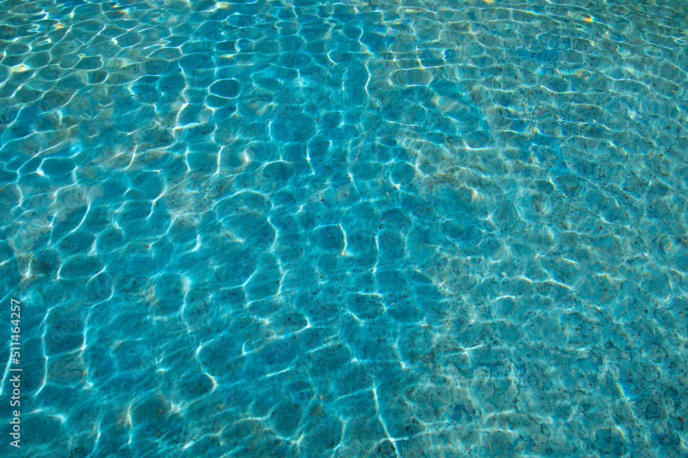 blue water surface with sun reflection