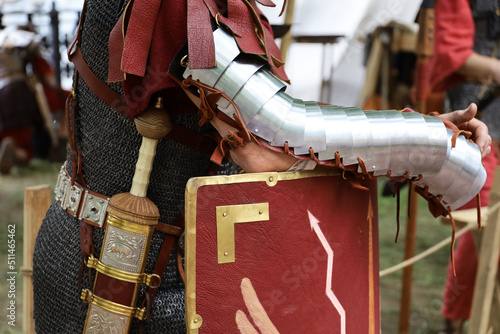 Legionary of Ancient Rome, close up of armor, gladius and scutum of infantry of Roman army on historical reconstruction festival photo