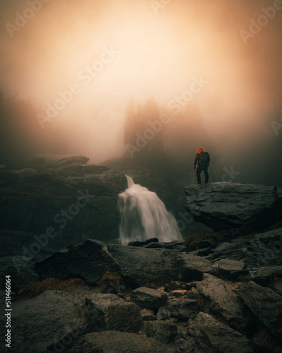 Man standing close to Waterfall. Famous Krimmler Waterfalls in Austria