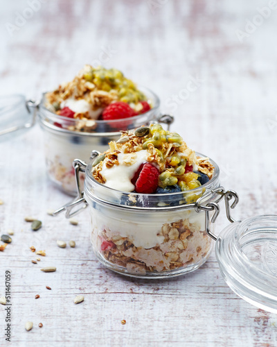 muesli with berries and yogurt on light background