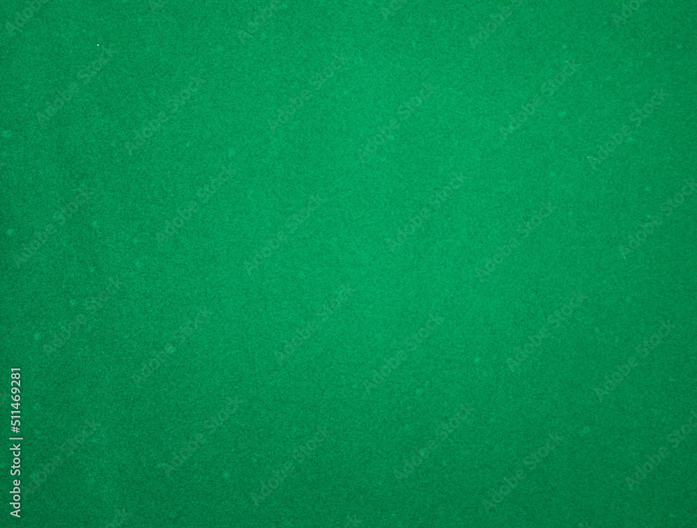 Green felt fabric close-up. Abstract background. The texture of the fibers. Velvet surface. Green felt fabric close-up. Abstract background. The texture of the fibers. Velvet surface.