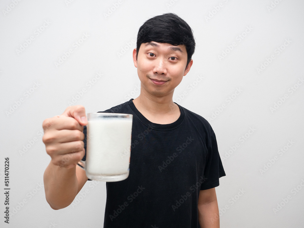 Young man giving glass of milk and smile face Young man giving glass of milk and smile face
