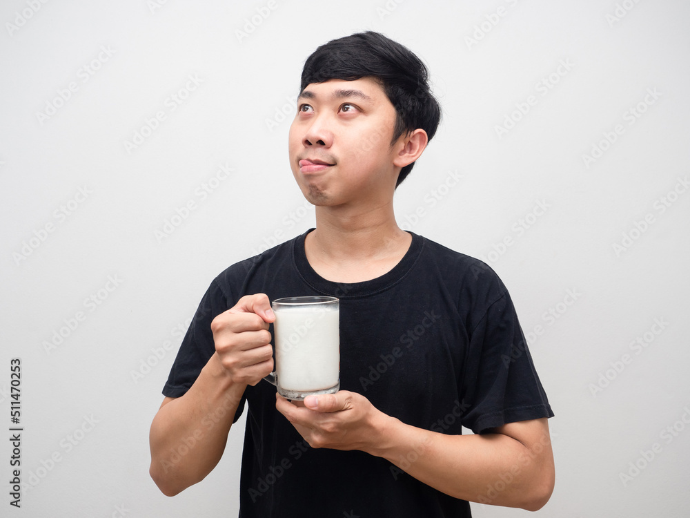 Young man holding milk gesture stick out tongue hungry food Young man holding milk gesture stick out tongue hungry food