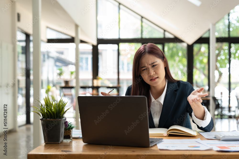 Young stressed businesswoman working at desk in modern office shouting at laptop screen and being angry about financial situation, jealous of rival capabilities, unable to meet client needs. Young stressed businesswoman working at desk in modern office shouting at laptop screen and being angry about financial situation, jealous of rival capabilities, unable to meet client needs.