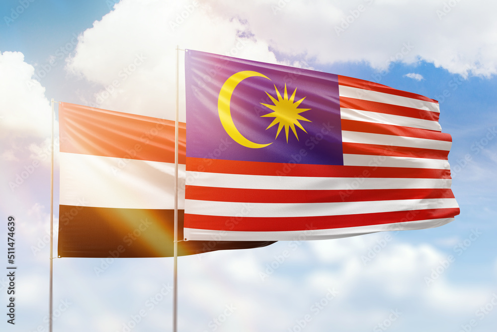 Sunny blue sky and flags of malaysia and yemen Sunny blue sky and flags of malaysia and yemen