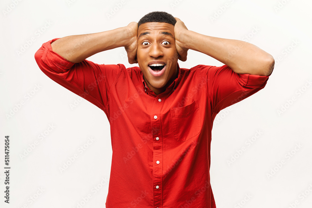 Stunned African-American guy looking at the camera with mouth open, surprised with amazing sale price multiracial young guy holding face with palms, shock male isolated on white wall Stunned African-American guy looking at the camera with mouth open, surprised with amazing sale price multiracial young guy holding face with palms, shock male isolated on white wall