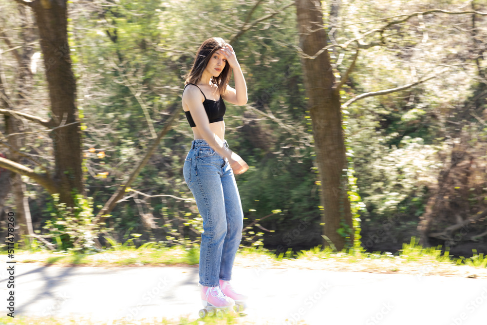brunette woman with pink roller skates in the park brunette woman with pink roller skates in the park