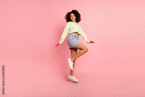 Full size profile side photo of young excited girl have fun jump up travel isolated over pink color background