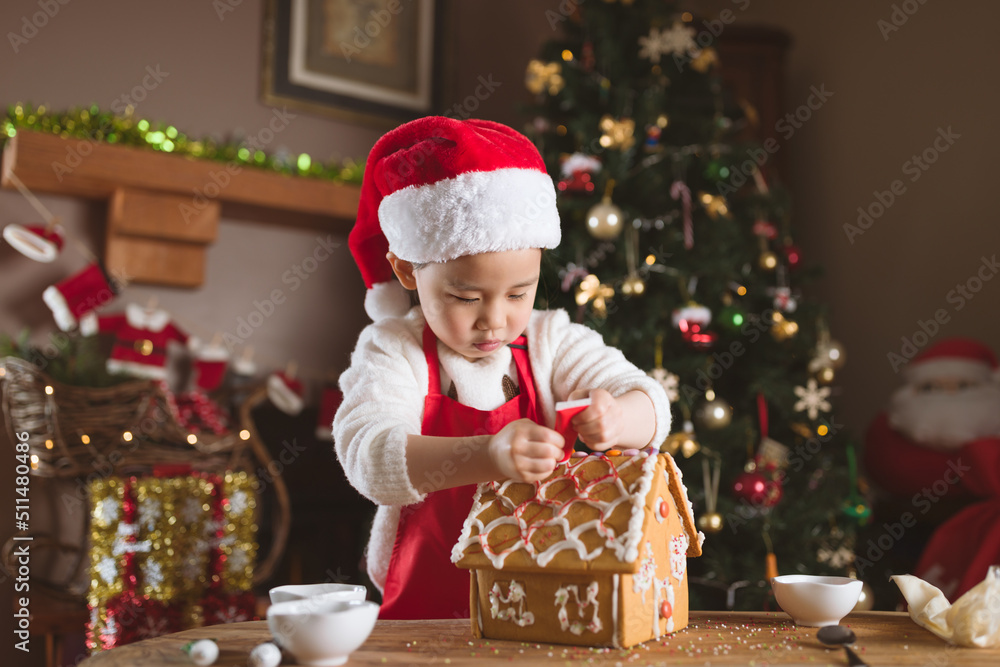 young girl making gingerbread house at home young girl making gingerbread house at home
