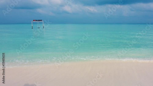 Calm blue sea and sandy beach in the Maldives photo