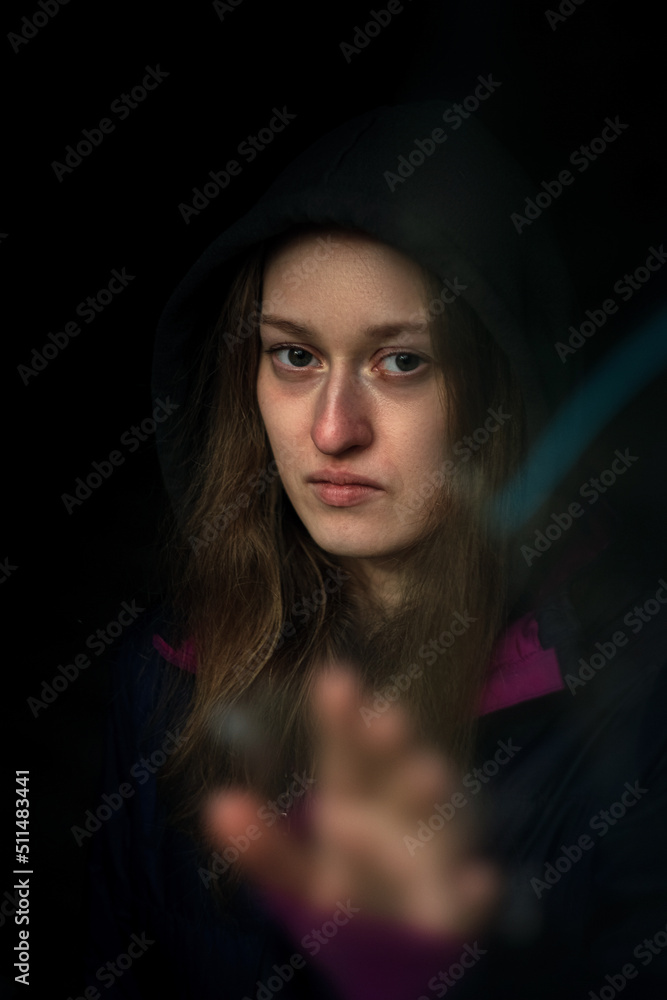 Portrait of a woman with her hand outstretched to the viewer Portrait of a woman with her hand outstretched to the viewer