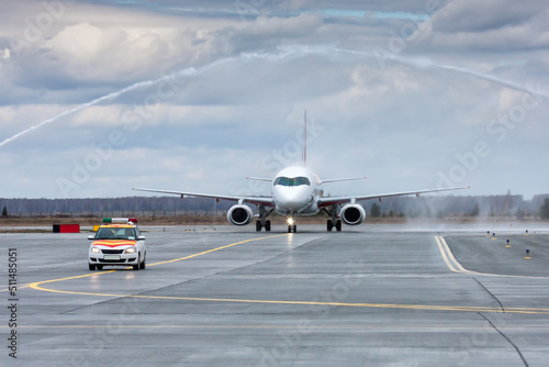 A passenger aircraft taxiing run the follow-me-car through a water salute in honor of the first visit © Dushlik