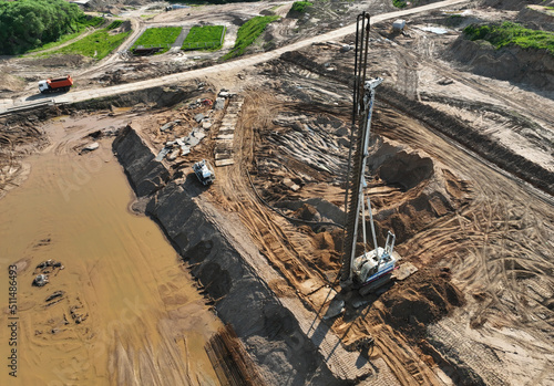 Deep foundation machine. Drilling rig and Pile driver at construction site. Pile driven into ground by vibrating hydraulic hammer. Foundations construction work. Ground drilling and Piling Contractor. photo