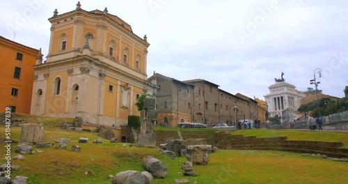 Low angle shot of area in front of Theatre of San Marcellus surrounded by old historical buildings in Rome, Italy at daytime. photo