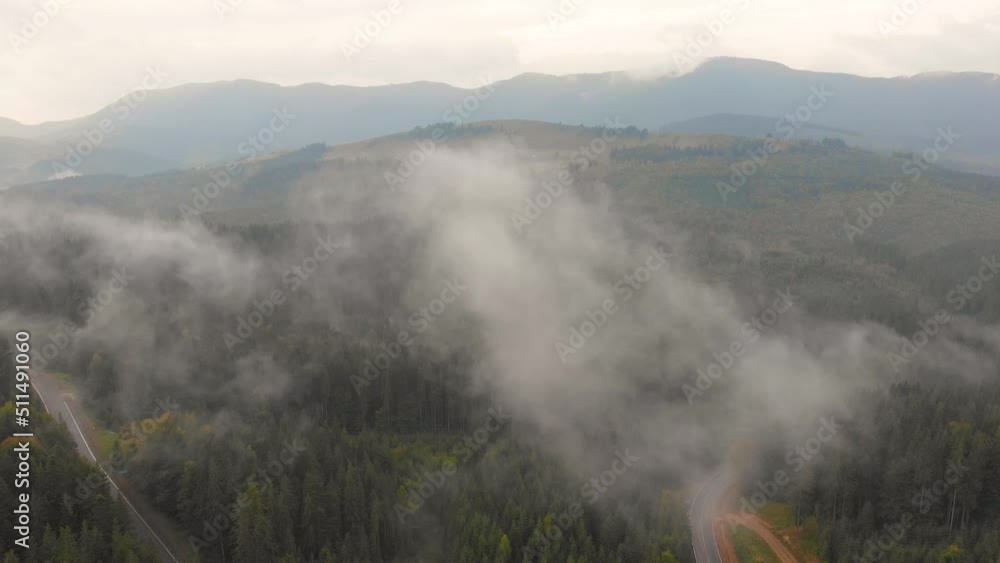 Drone flies over clouds on sunny day, summer mountain peaks in distance on horizon. Inspiring and mesmerizing calm tranquil shot of flying. Travel destination idyllic nature concept Drone flies over clouds on sunny day, summer mountain peaks in distance on horizon. Inspiring and mesmerizing calm tranquil shot of flying. Travel destination idyllic nature concept