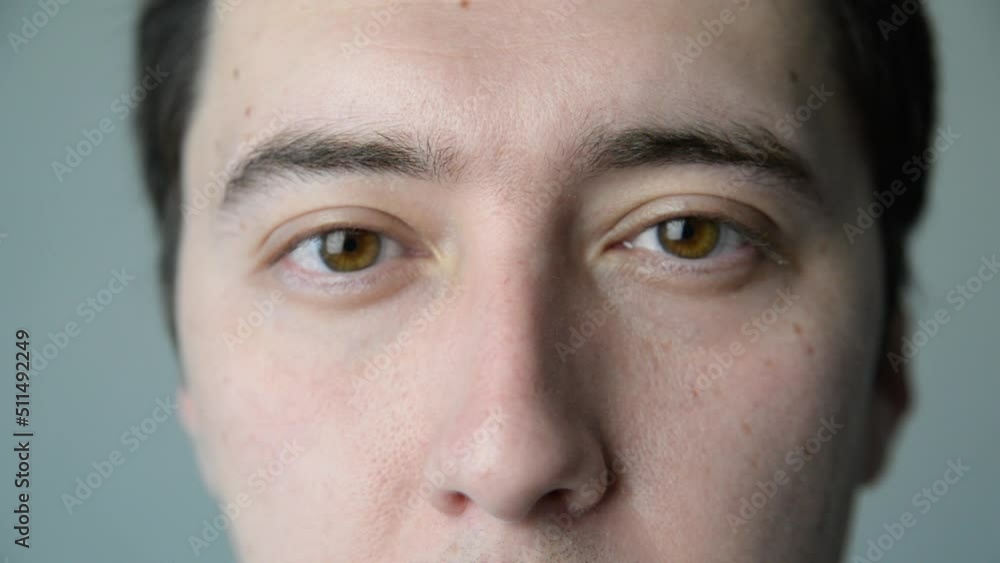 the man opens his eyes. face of a young man close-up. look, the eyes of a brown-eyed man. awakening concept the man opens his eyes. face of a young man close-up. look, the eyes of a brown-eyed man. awakening concept