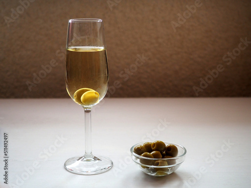 A glass of dry sherry and olives