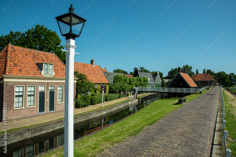 Fototapeta premium Enkhuizen, Netherlands, June 2022. View through one of the many historical streets in Enkhuizen.
