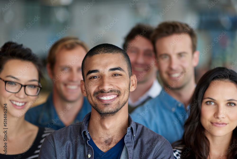 Feeling proud of our achievments. Shot of a smiling group of coworkers standing in an office. Feeling proud of our achievments. Shot of a smiling group of coworkers standing in an office.