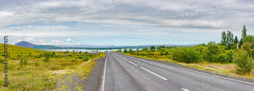 Panoramic view over Ring road to Myvatn lake near Reykjahlid in Northern Iceland, at summer time, dramatic sky and sunny day.