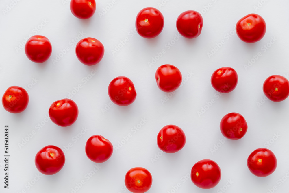 Flat lay with cherry tomatoes on white background. Flat lay with cherry tomatoes on white background.