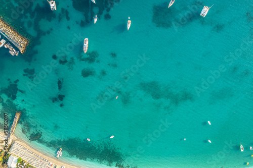 Port, dock with boats, cruise ship, yachts in blue, turquoise sea water. Summer vacations and travel concept. Marina. Aerial, top, drone view
