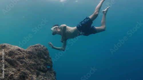 Wallpaper Mural Skin diving. Young fit man dives with mask in the sea and swims underwater Torontodigital.ca