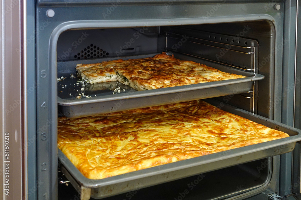 Turkish style water pastry baked in the oven, a tray full of pastries,