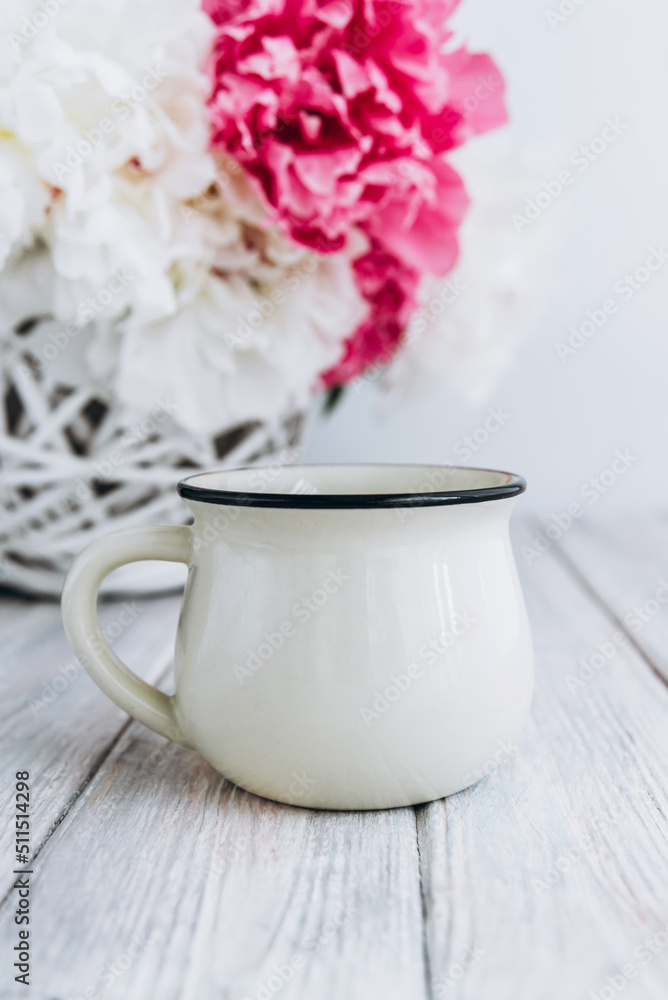 White cup of tea on table with peony flowers bouquet, mockup White cup of tea on table with peony flowers bouquet, mockup