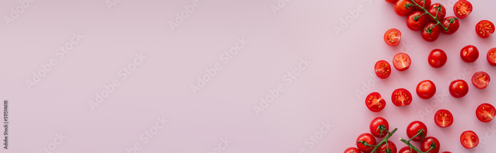Top view of organic cherry tomatoes on pink surface, banner. Top view of organic cherry tomatoes on pink surface, banner.