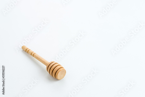 Honey dipper or spoon for honey, isolated on white background, copy space.
