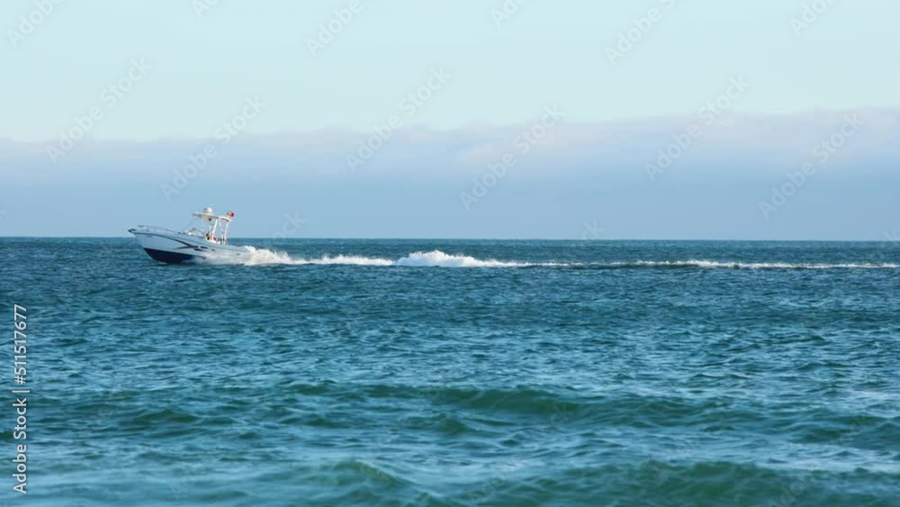 Tourist speed boat riding along a beautiful coast in Algarve province, Portugal Tourist speed boat riding along a beautiful coast in Algarve province, Portugal