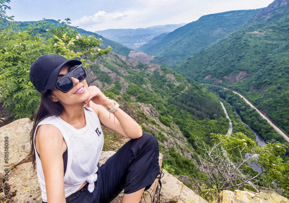 Young Smiling  Woman with Hat and Sunglasses  in the High Summer Mountain with Stunning View 