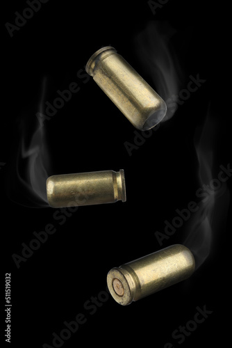 Картината върху платно Cartridge cases with smoke falling on black background