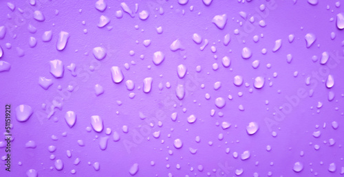 Abstract water drops on the violet wall. Suitable for promotion and advertising, website, tech industry and company, etc.