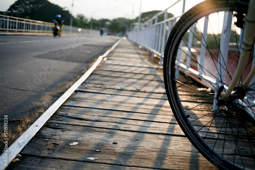 Front wheel of bicycle in wooden bridge