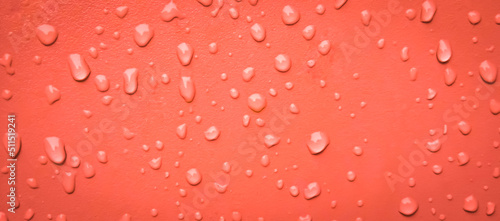 Abstract water drops on the orange wall. Suitable for promotion and advertising, website, tech industry and company, etc.