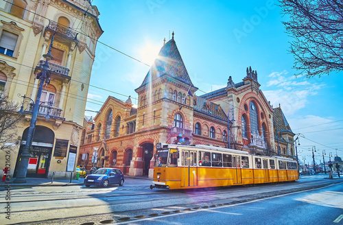 Print op canvas The yellow tram in front of Central Market Hall, Budapest, Hungary