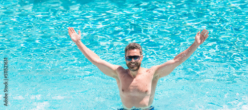 happy handsome guy in sunglasses swimming in pool on summer, pool party. Man face portrait, banner with copy space.