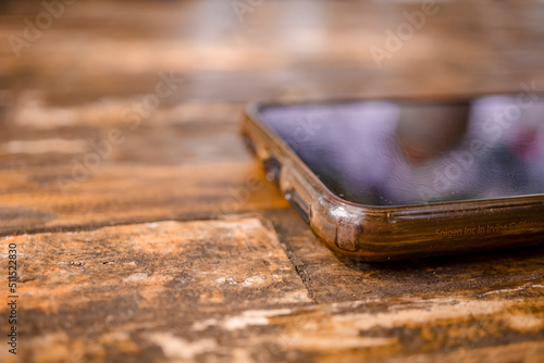 Close up of handphone on the wooden table. The photo is prefect for product background and advertising.  photo