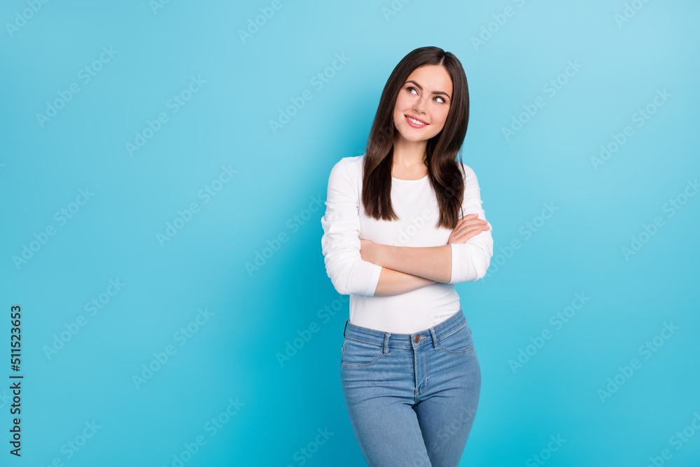 Portrait of attractive minded cheerful brunet girl assistant folded arms making solution isolated over vivid blue color background Portrait of attractive minded cheerful brunet girl assistant folded arms making solution isolated over vivid blue color background
