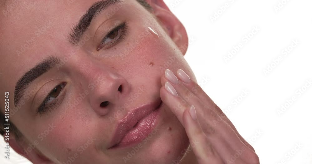 Close up of a white woman's face applying essential oil to her skin. Isolated on white background. Close up of a white woman's face applying essential oil to her skin. Isolated on white background.