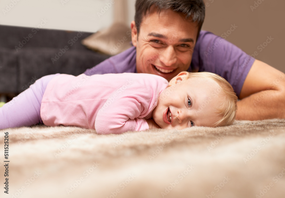 Proud of my child. Portrait of a baby lying on the floor with the father in the background. Proud of my child. Portrait of a baby lying on the floor with the father in the background.