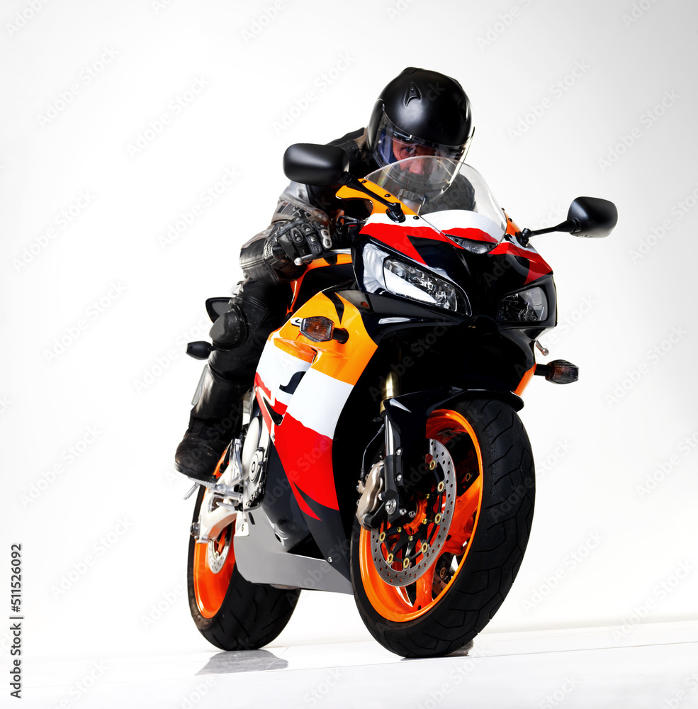 Daredevil. Full length studio shot of a biker racing a superbike. Daredevil. Full length studio shot of a biker racing a superbike.