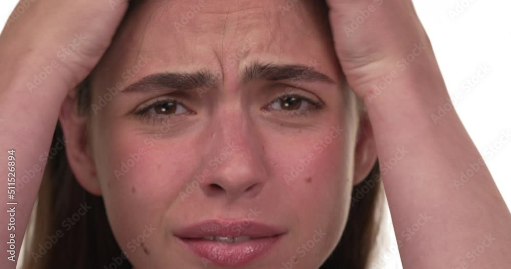 Close up on a woman's head scratching intensively her scalp, showing unpleasant expression on her face. Close up on a woman's head scratching intensively her scalp, showing unpleasant expression on her face.