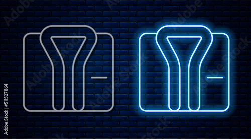 Glowing neon line Bathrobe icon isolated on brick wall background. Vector