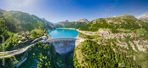 Stampa su tela Water dam and reservoir lake aerial panoramic view in French Alps mountains generating hydroelectricity
